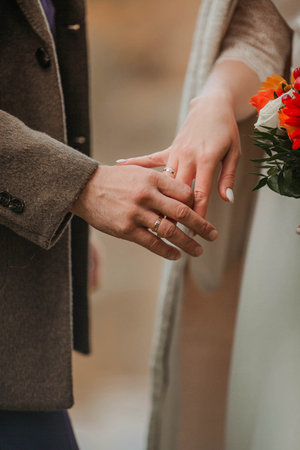 wedding rings of the bride and groom on their handsの写真素材