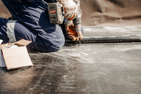roof repair. a roofer repairs the roof. roofing toolsの写真素材