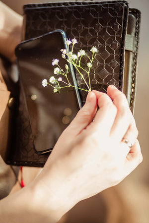 organizer in the hands of a woman with a flowerの写真素材