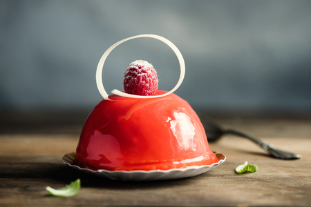 Pastry, dessert, raspberry cheese cake. Minimalistic style. Rustic background. Toned, selective focusの写真素材