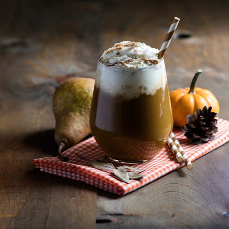 Pumpkin latte with spices, coffee autumn of fall drink with pumpkins, Thanksgiving table, copy space, selective focusの写真素材