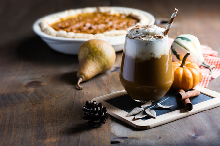 Pumpkin latte with spices, coffee autumn of fall drink with pumpkins, Thanksgiving table, copy space, selective focusの写真素材