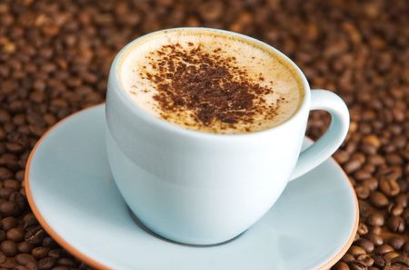 cappuccino on table with coffee beansの写真素材