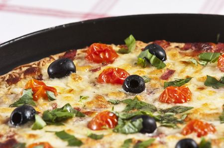 baked pizza served on wooden boardの写真素材