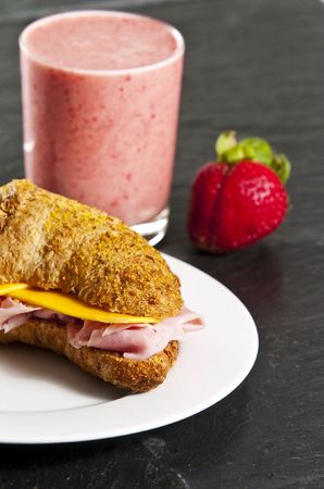 Continental breakfast with croissant and strawberry smoothieの写真素材