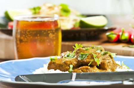 Chicken curry served  with rice and garnished with cilantro leavesの写真素材