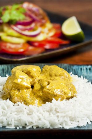 Chicken curry served  with rice and garnished with cilantro leavesの写真素材