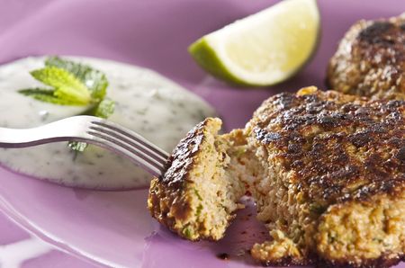 Lamb shami kebabs served on lilac plate with yogurt and mint sauceの写真素材