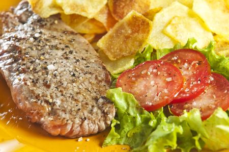 Juicy beef steak with chips and saladの写真素材
