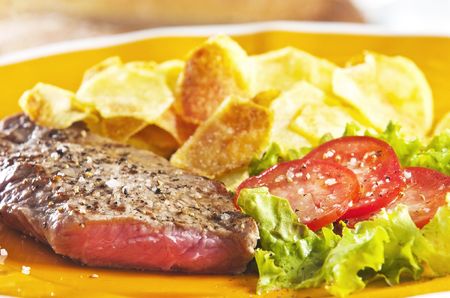 Juicy beef steak with chips and saladの写真素材