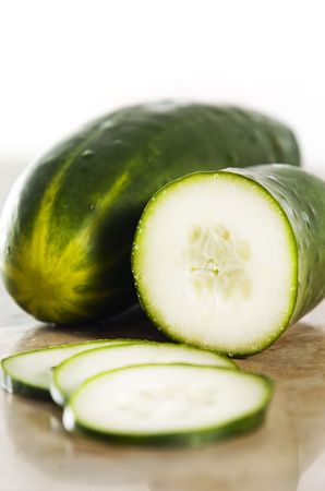 green cucumber on a stone counterの写真素材