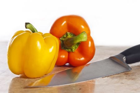 Yellow and orange paprika on a stone counterの写真素材