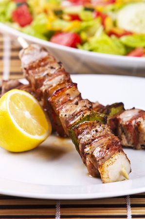 Grilled chicken kebab served with a fresh saladの写真素材