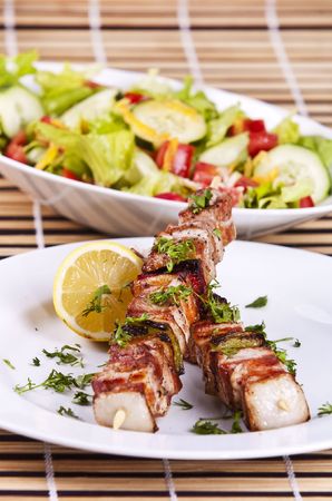 Grilled chicken kebab served with a fresh saladの写真素材