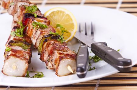 Grilled chicken kebab served on a white plateの写真素材