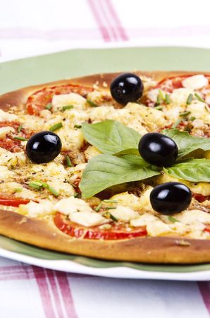baked pizza served on a green plateの写真素材