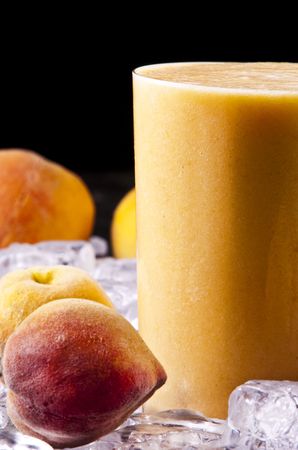 A glass of freshly made peach smoothieの写真素材