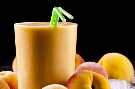 A glass of freshly made peach smoothieの写真素材