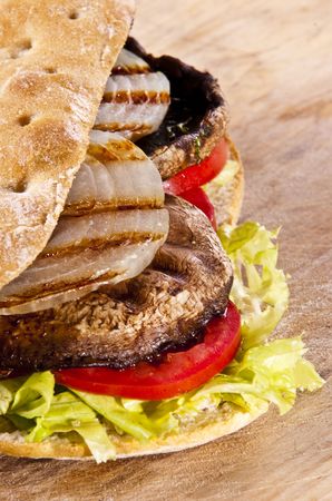 Portobello sandwich with grilled onion lettuce and tomatoの写真素材