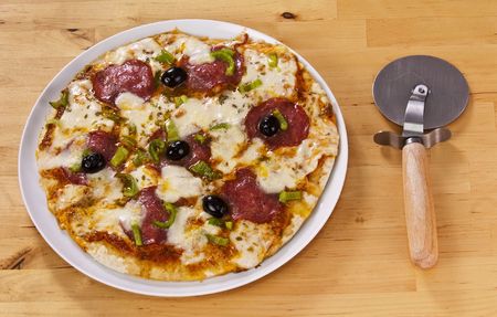 peperoni pizza served on a wood tableの写真素材