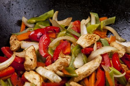 Chicken stir fry with red peppers onion and green beans の写真素材