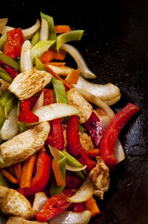 Chicken stir fry with red peppers onion and green beans の写真素材