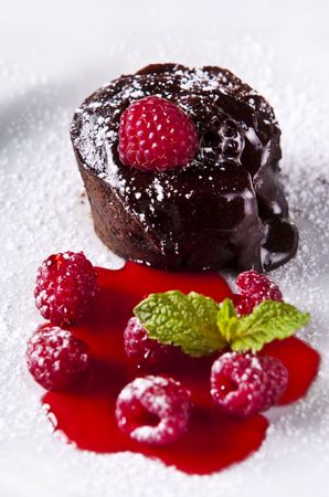 Delicious chocolate dessert with fresh raspberries and syrupの写真素材