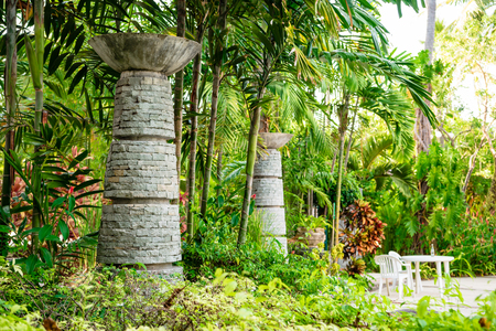 Stone brick towers placed in lush green foliage of resort hotel, Phuket, Thailand.の写真素材