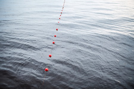 Yachts moorings red buoy of small European marina