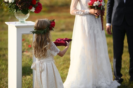 little girl Carrying Wedding Ring On Cushion.の写真素材