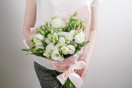 Vintage floristic background, colorful roses, antique scissors and a rope on an wooden tableの写真素材