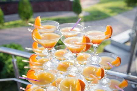 Pyramid from glasses at celebration. Colorful cocktails close up. an open-air party On the Sunset.の写真素材