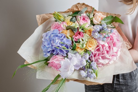 Florist at work. Make Serenity hydrangea rich bouquet. flowers in their hands.の写真素材