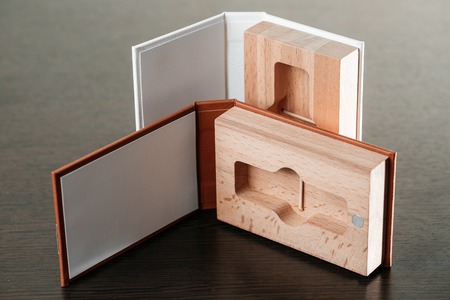 Packaging for USB drives. Box with usb-stick for photographer. Wooden boxes with usb stick on dark...