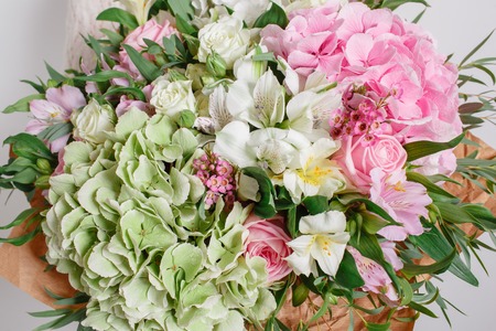 flower composition with hydrangea and roses. Color pink green. Kraft paper. crisp packaging.の写真素材