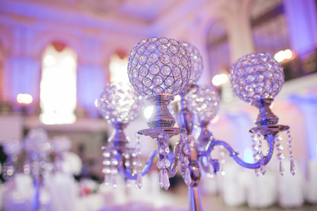 Beautiful restaurant interior table decoration for wedding. Flower . White orchids in vases. luxury candleholders.の写真素材