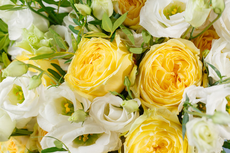 bunch of white eustoma and yellow roses flowers, green leaf Fresh spring bouquet. Summer Background.の写真素材