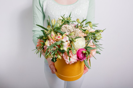 rich bouquet with hydrangea in woman hand . colorful roses and various color mix flowers.の写真素材