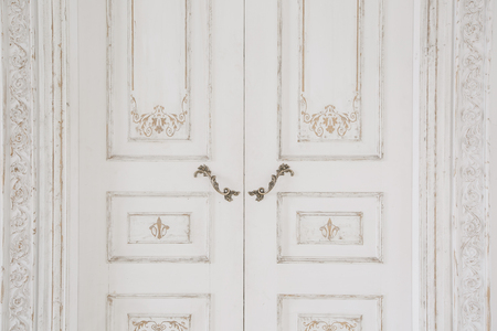 Old-style door, white old-style handle closeup. antiques interior.の写真素材