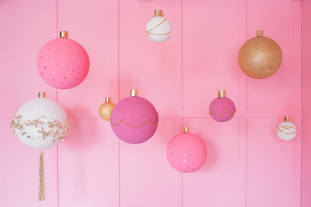 Large Christmas balls on a pink background in children room.の写真素材