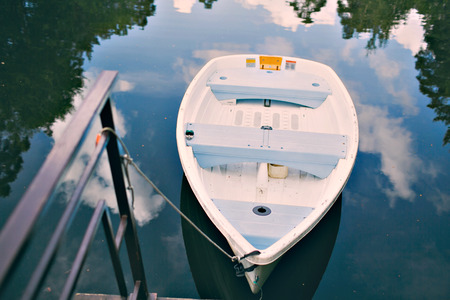 boat stand on a forest lake during the peak of summer in mountainsの写真素材