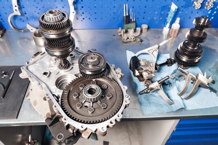 Cross-section of a car gearbox. mechanics work in the garage.