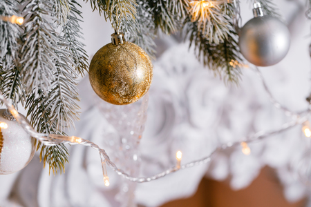 light from the garlands. Christmas tree decorated ball close-upの写真素材