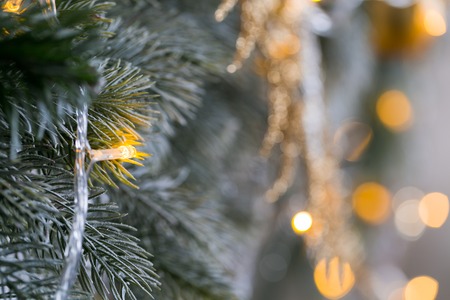 light from the garlands. Christmas tree decorated ball close-upの写真素材