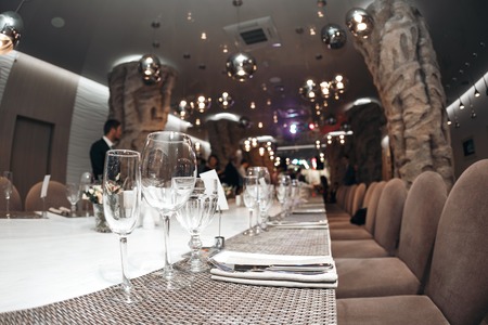 Wedding. Banquet. The chairs and table for guests, served with cutlery and crockery.の写真素材