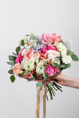 Rich bunch flowers in hand Fresh spring bouquet. Summer Background.の写真素材