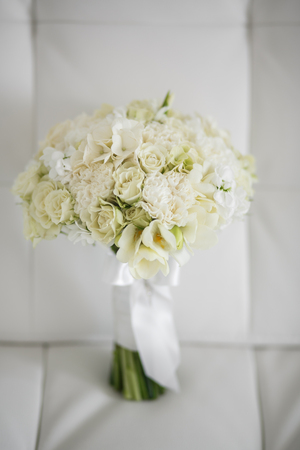 Wedding bouquet made of white roses on a white backgroundの写真素材