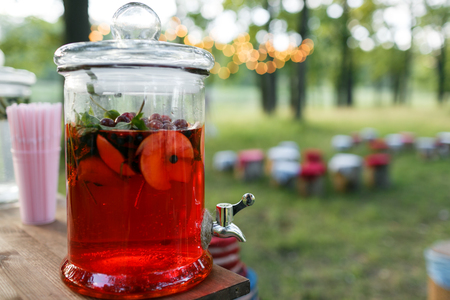 lemonade and Compote in large glass jar. Summer fruit drink in glass jar. Style rustic.の写真素材