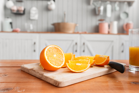 sliced oranges on a wooden cutting board. Healthy and tasty breakfastの写真素材