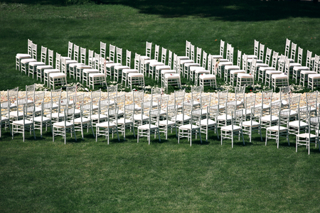 Beautiful wedding ceremony design decoration elements with fresh flowers composition, floral design, petals roses and chairs.の写真素材